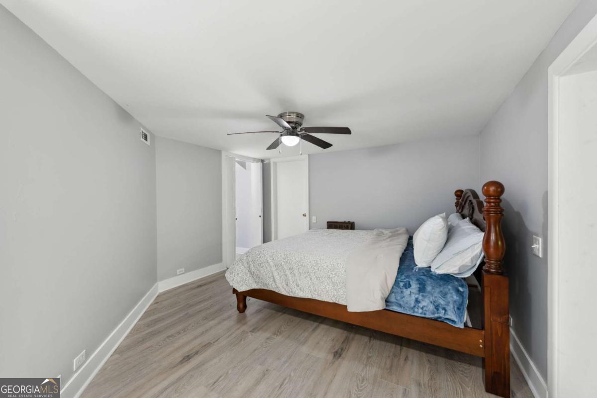 10323 Grassy Mountain Road Ellijay, GA 30540 - Photo 24 of 70 a bedroom with a bed and a chandelier