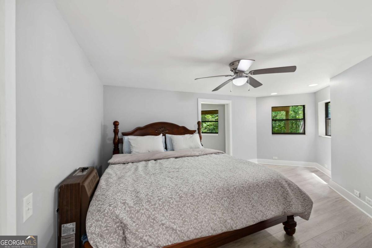 10323 Grassy Mountain Road Ellijay, GA 30540 - Photo 25 of 70 a bedroom with a bed and a chandelier
