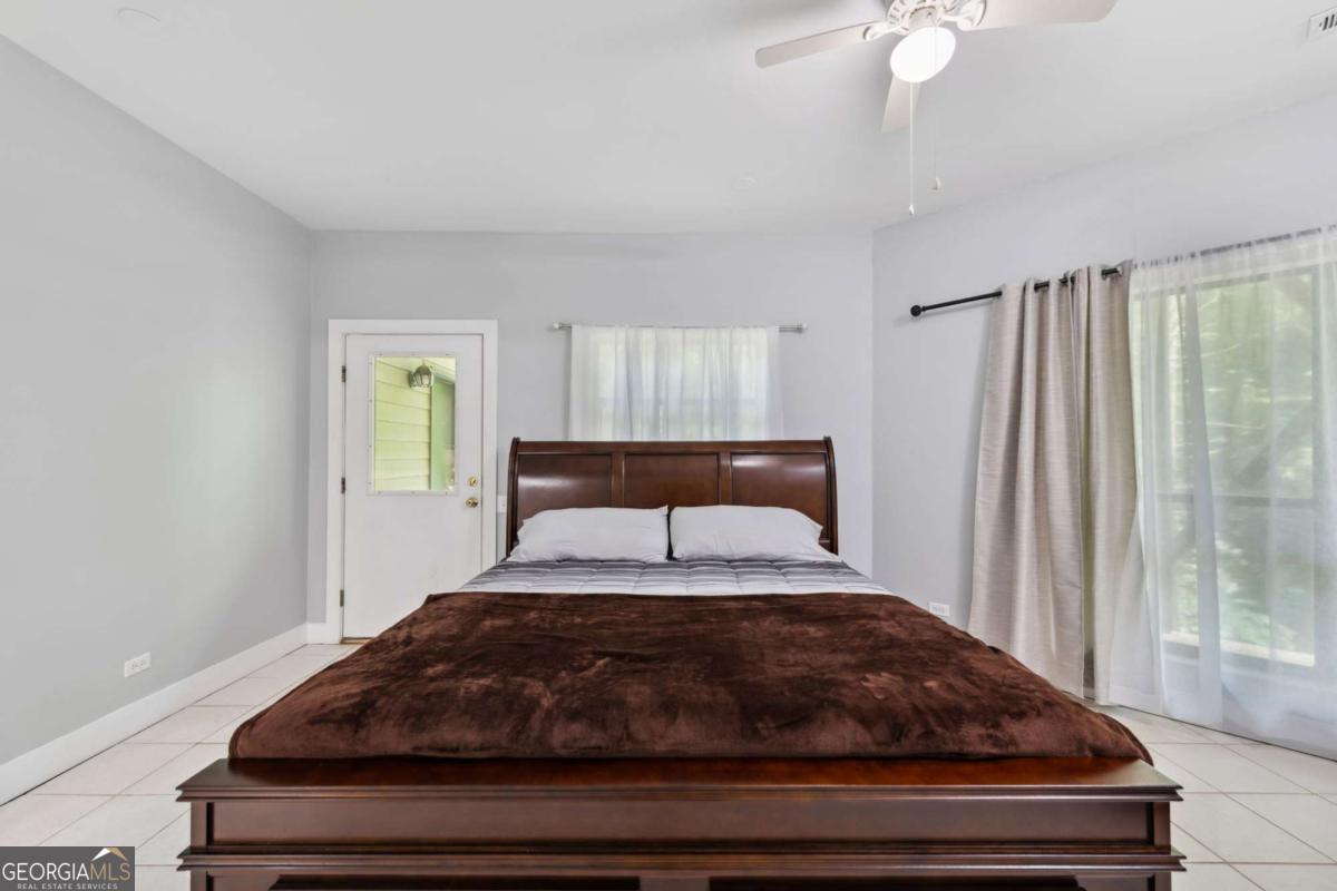 10323 Grassy Mountain Road Ellijay, GA 30540 - Photo 32 of 70 a bedroom with a bed and window