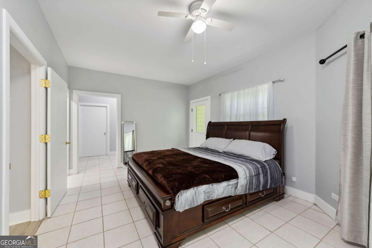 10323 Grassy Mountain Road Ellijay, GA 30540 - Photo 33 of 70 a bedroom with a bed and a chandelier