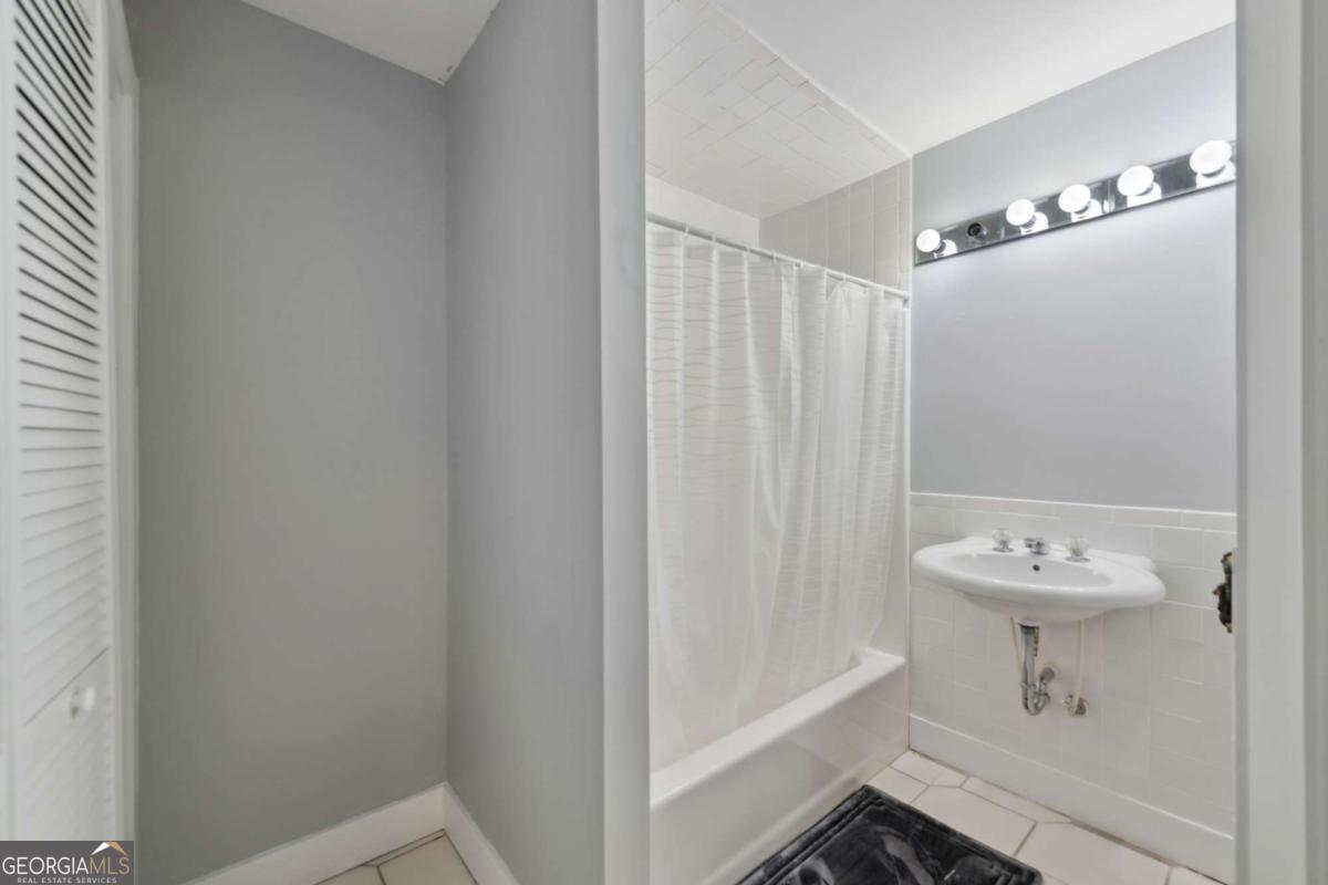 10323 Grassy Mountain Road Ellijay, GA 30540 - Photo 38 of 70 a bathroom with a sink a toilet and shower