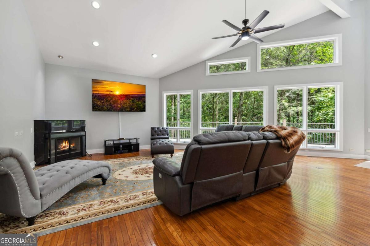 10323 Grassy Mountain Road Ellijay, GA 30540 - Photo 54 of 70 a living room with furniture flat screen tv and a large window