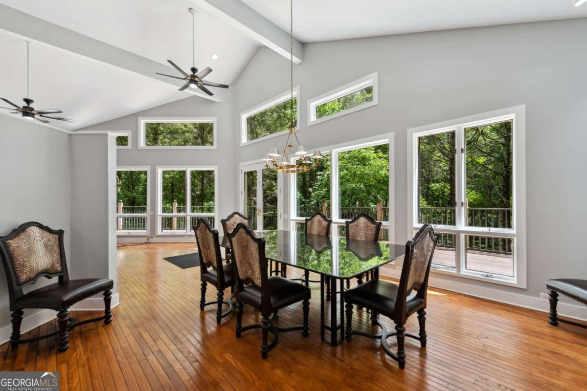 10323 Grassy Mountain Road Ellijay, GA 30540 - Photo 58 of 70 a view of a dining room with furniture window and wooden floor