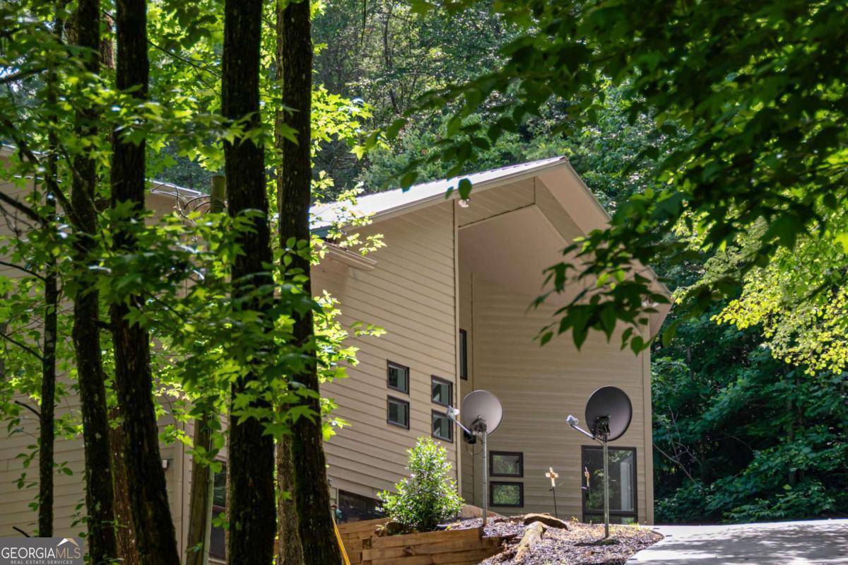 10323 Grassy Mountain Road Ellijay, GA 30540 - Photo 68 of 70 a front view of a house with a yard and tree s
