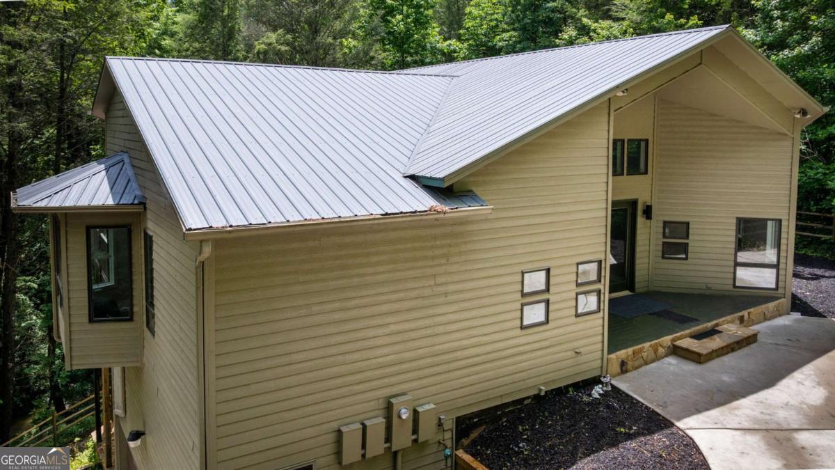10323 Grassy Mountain Road Ellijay, GA 30540 - Photo 9 of 70 a view of a house with a patio