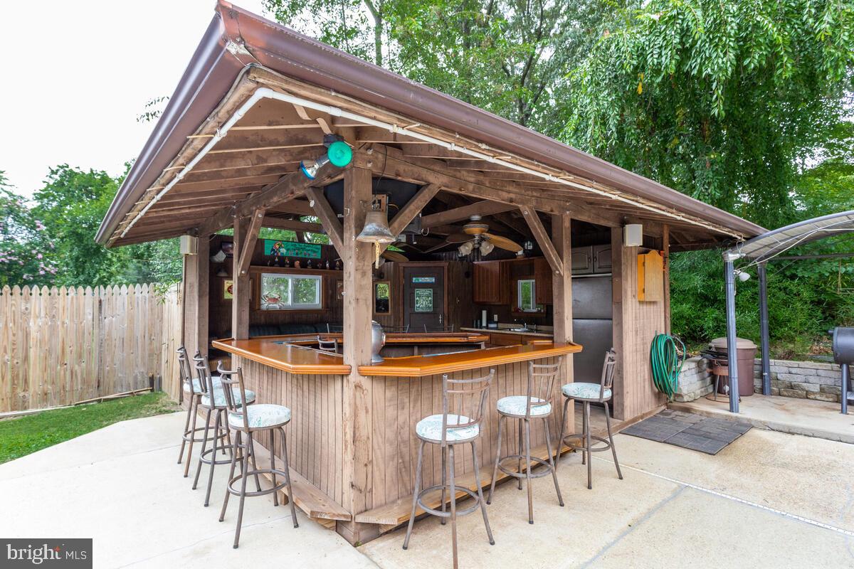 824 Windsor Road Arnold, MD 21012 - Photo 38 of 45 824 Windsor Rd- pool house bar, barstools convey