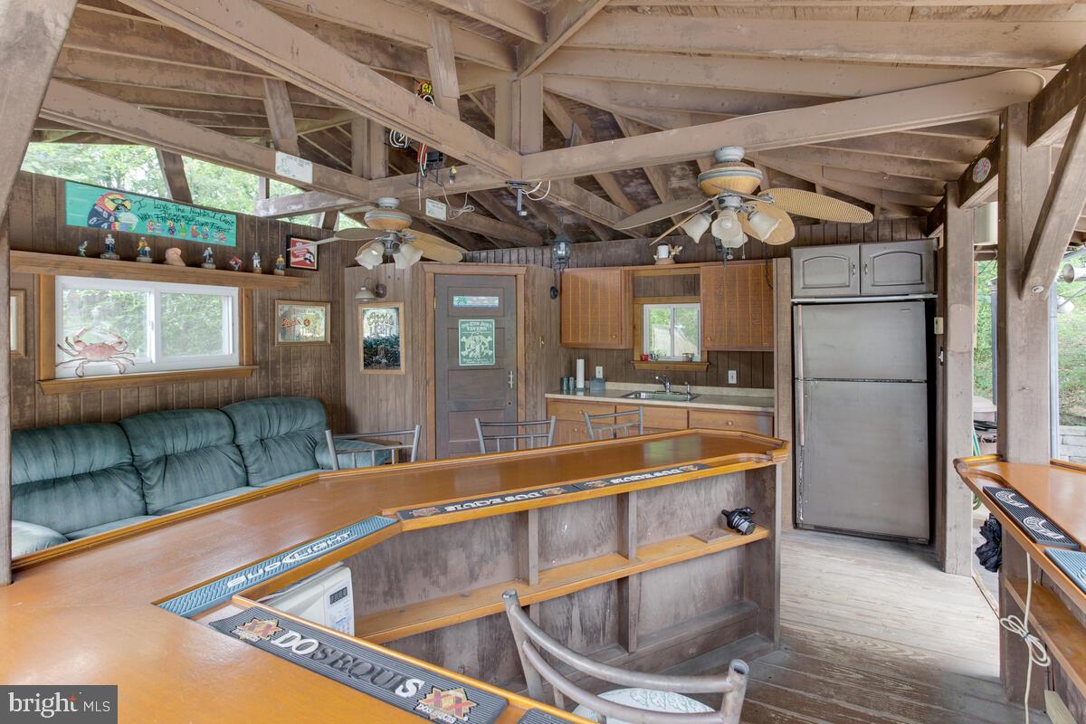 824 Windsor Road Arnold, MD 21012 - Photo 41 of 45 824 Windsor Rd - pool house bar w/ceiling fans