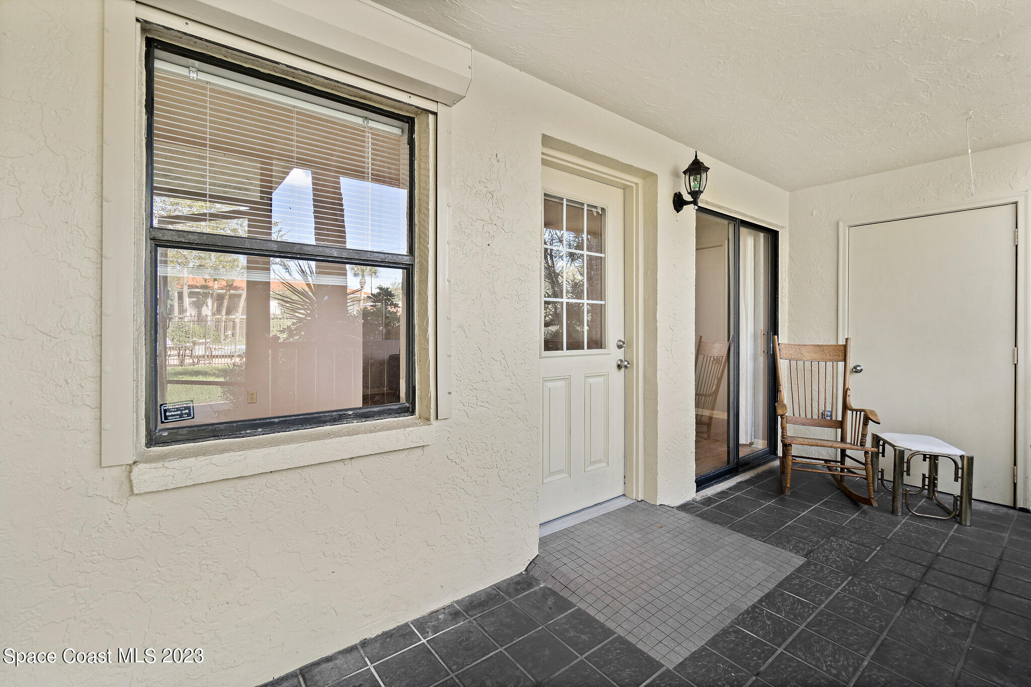 500 Catalina Road, Unit 103 Cocoa Beach, FL 32931 - Photo 6 of 28 a view of livingroom with furniture and windows
