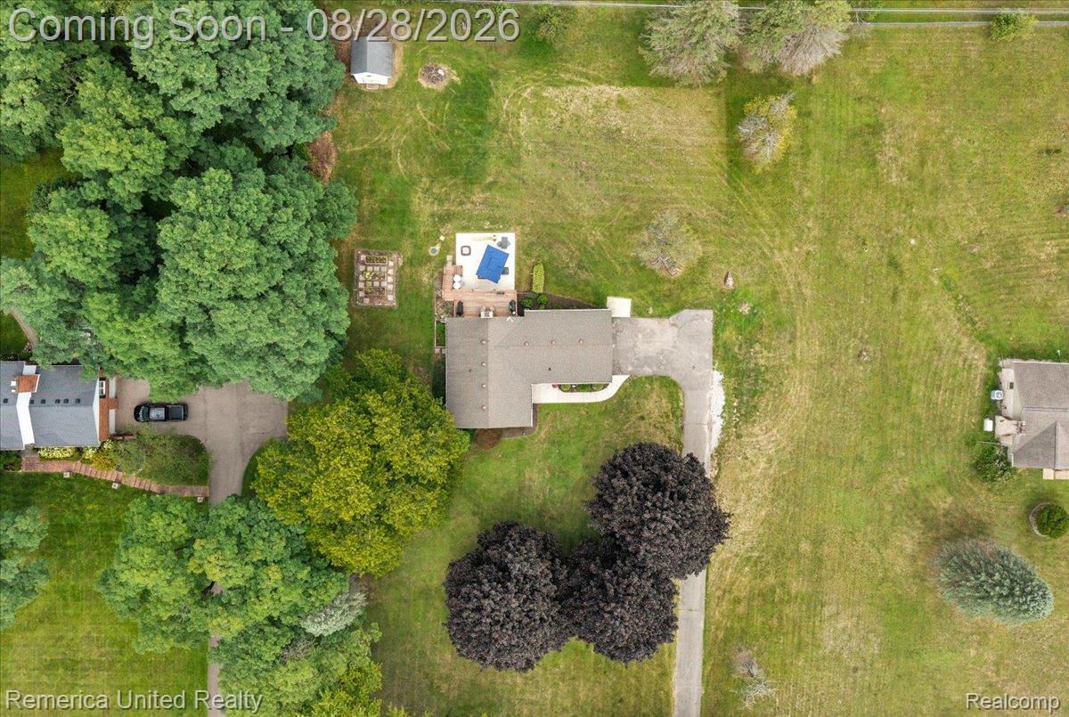 3687 Van Amberg Road Brighton, MI 48114 - Photo 52 of 56 Spacious lot featuring mature trees, a private driveway, a detached shed, a paved patio, and a dedicated garden area