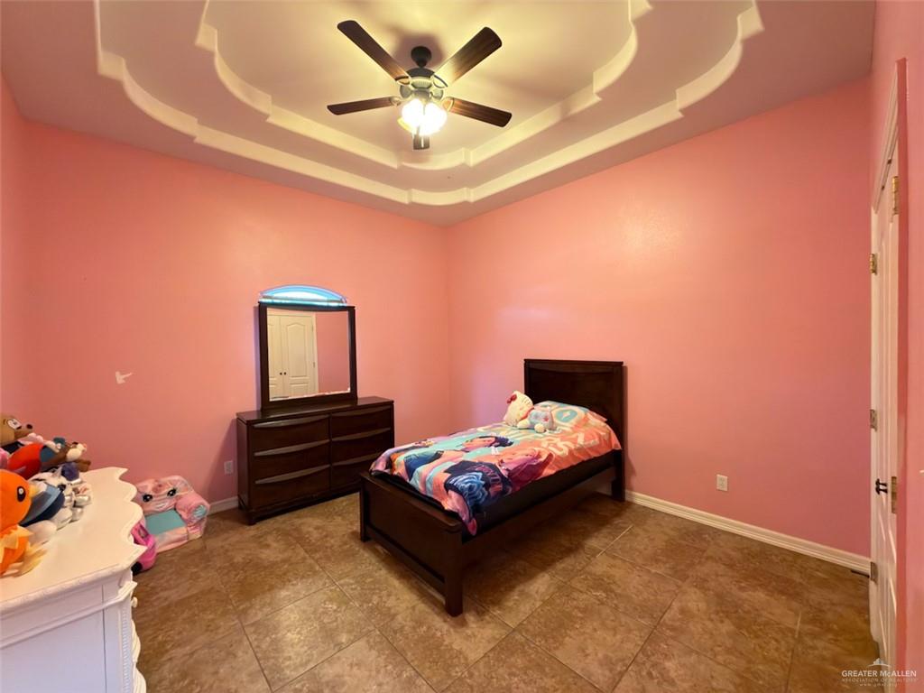 208 North 15th Street Hidalgo, TX 78557 - Photo 16 of 26 a bedroom with a bed and a chandelier