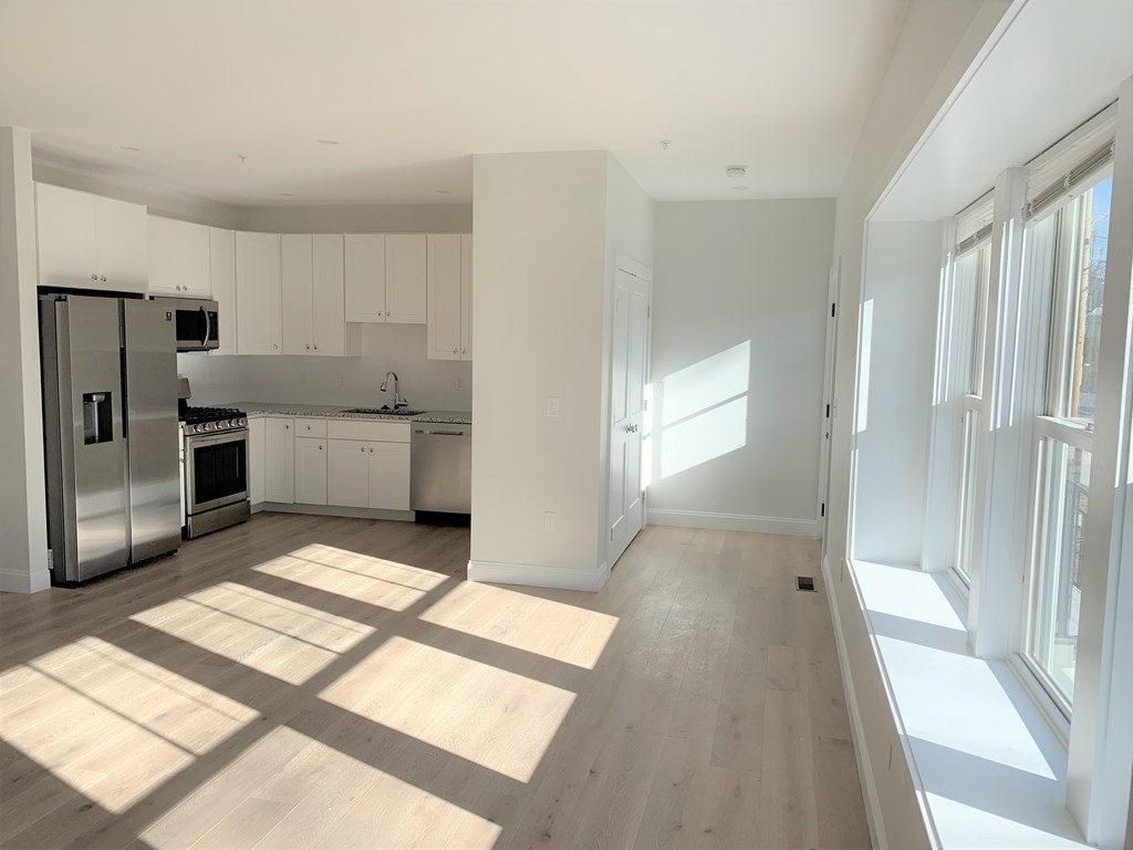 1 Broadway Avenue, Unit 2 Ipswich, MA 01938 - Photo 1 of 8 a view of a kitchen with a sink and refrigerator