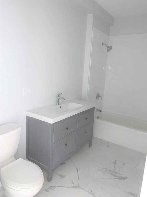 1 Broadway Avenue, Unit 2 Ipswich, MA 01938 - Photo 8 of 8 a bathroom with a sink a toilet and shower