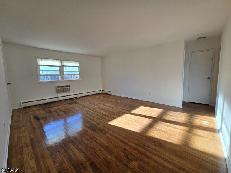 87 Elm Road, Unit 6A Caldwell, NJ 07006 - Photo 4 of 6 a view of empty room with wooden floor and fan