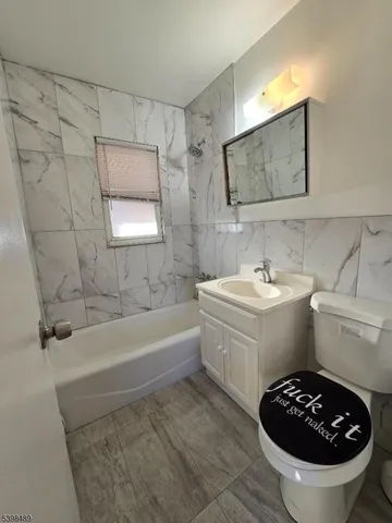 a bathroom with a sink a bathtub and a toilet