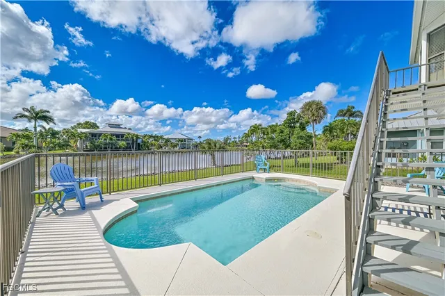 a view of a swimming pool with a patio and a garden