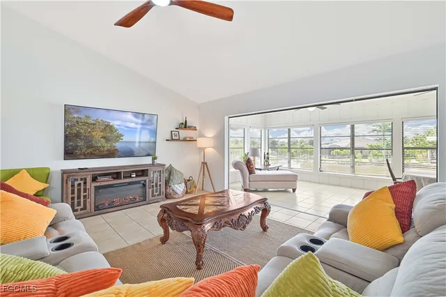 a living room with furniture and a floor to ceiling window