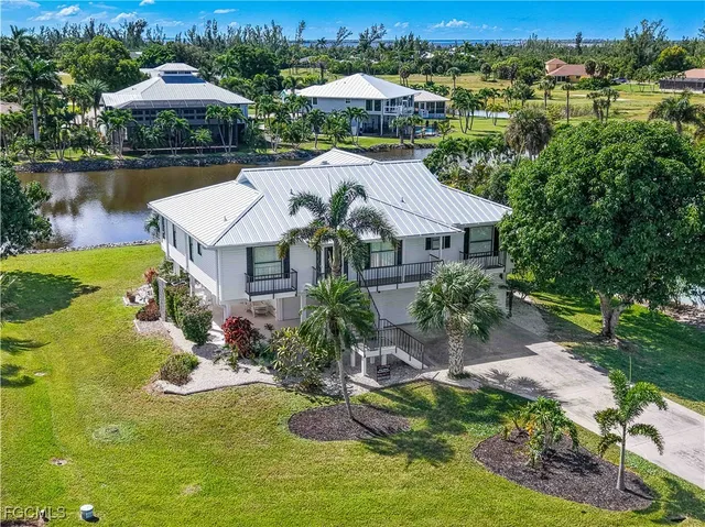 a aerial view of a house with yard swimming pool and outdoor seating