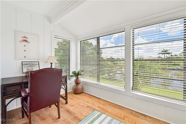 a spacious en suite bathroom with a double vanity sink a large mirror and a window