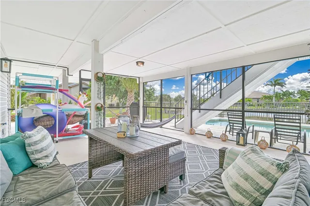 a living room with furniture and a floor to ceiling window