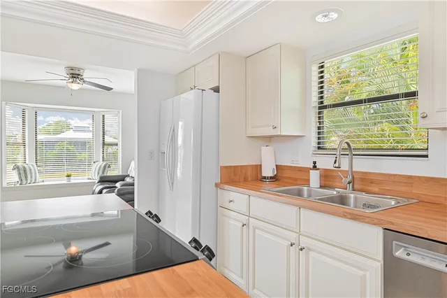 a kitchen with stainless steel appliances granite countertop a sink and a stove