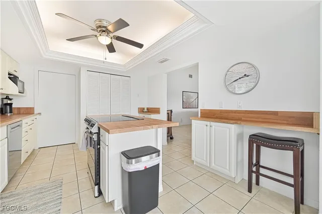 a kitchen with granite countertop white cabinets and a window