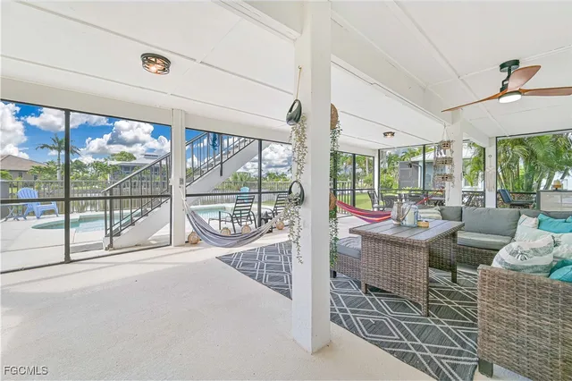 a living room with furniture and a floor to ceiling window