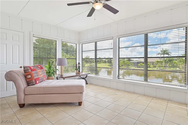 a living room with furniture and large windows
