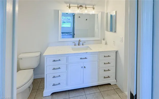 a bathroom with a double vanity sink and mirror