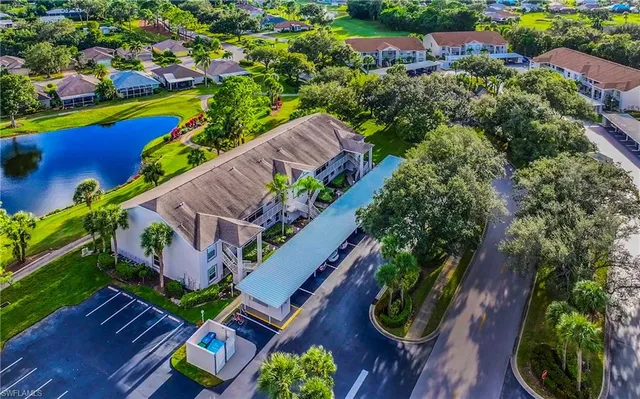 an aerial view of a swimming pool with lawn chairs