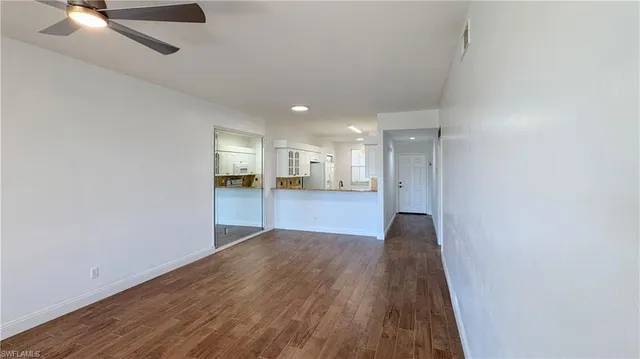 a view of a kitchen with wooden floor and a kitchen