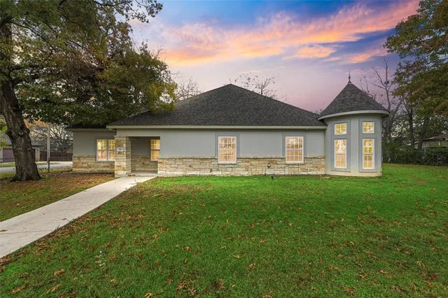 a front view of a house with yard patio and green space