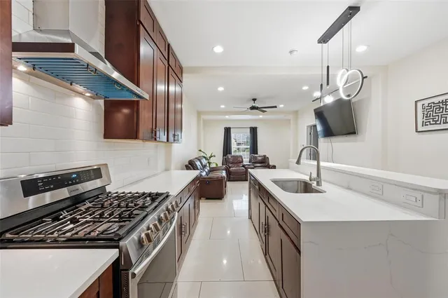 a kitchen with lots of counter space and stainless steel appliances