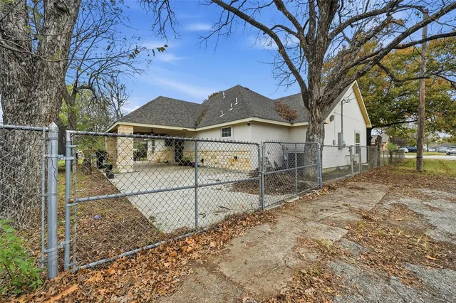 a view of a house with a large tree in front of a house