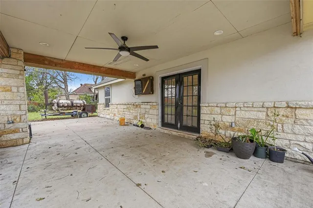 a view of a patio with a table and chairs under an umbrella