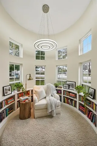 a bedroom with furniture and a book shelf