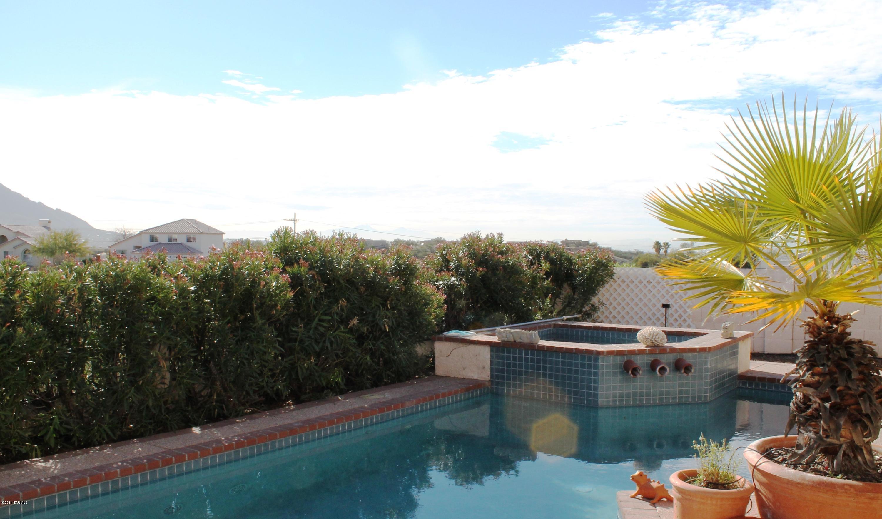 11286 North Copper Spring Trail Tucson, AZ 85737 - Photo 7 of 8 a view of a swimming pool with a patio