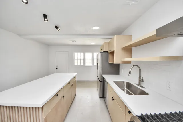 a kitchen with a sink and a refrigerator