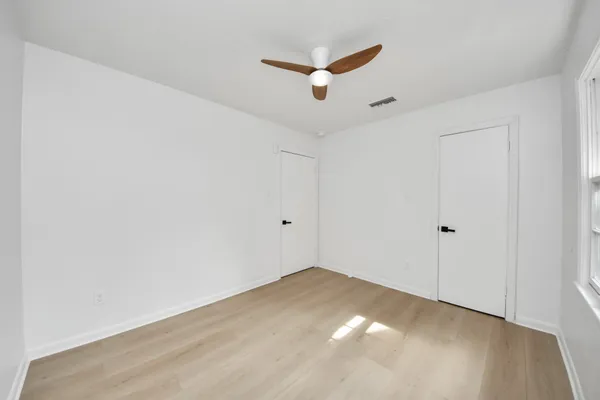 a view of a room with a ceiling fan