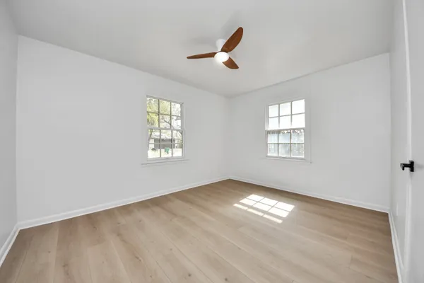 wooden floor in an empty room with a window