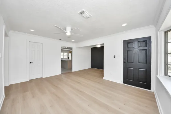 a view of an empty room with a kitchen
