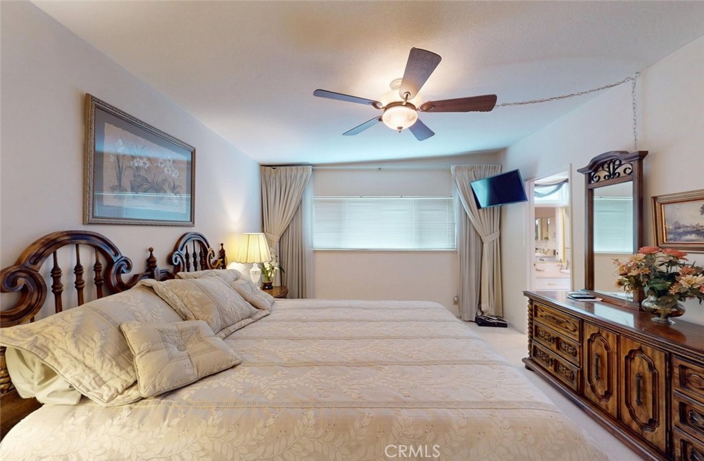 9901 Westhaven Circle Westminster, CA 92683 - Photo 27 of 41 a view of a bedroom with furniture and chandelier fan