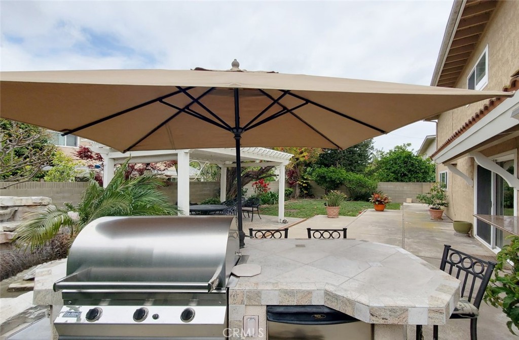 9901 Westhaven Circle Westminster, CA 92683 - Photo 35 of 41 a patio with table and chairs under an umbrella