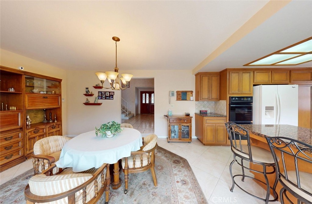 9901 Westhaven Circle Westminster, CA 92683 - Photo 9 of 41 a dining room with furniture a chandelier and window