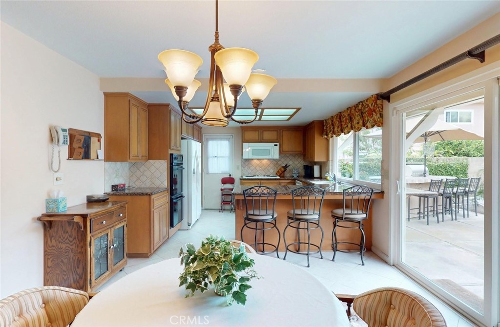 9901 Westhaven Circle Westminster, CA 92683 - Photo 10 of 41 a dining room with furniture a large window and wooden floor