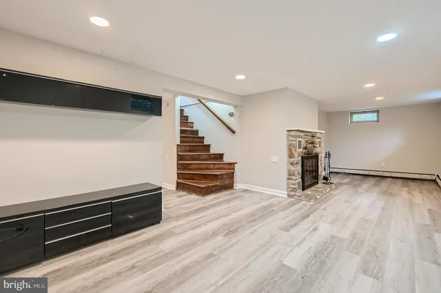 an empty room with wooden floor and stairs