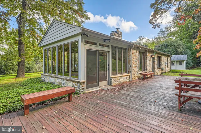 a backyard of a house with barbeque oven table and chairs