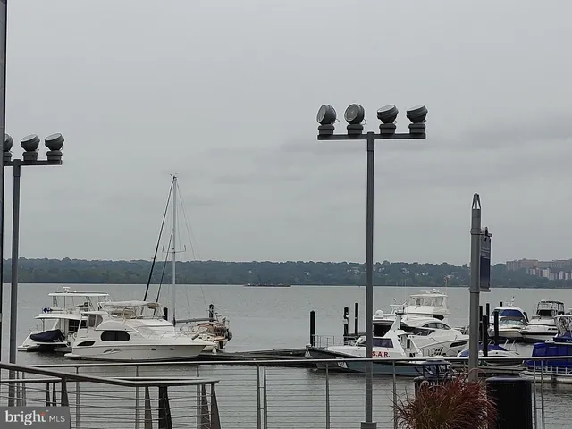 a view of a sink with granite countertop and a lake view
