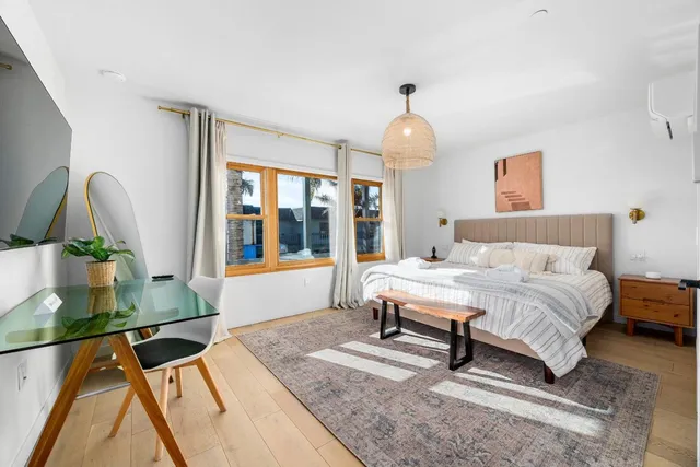 a bedroom with a bed and a chandelier