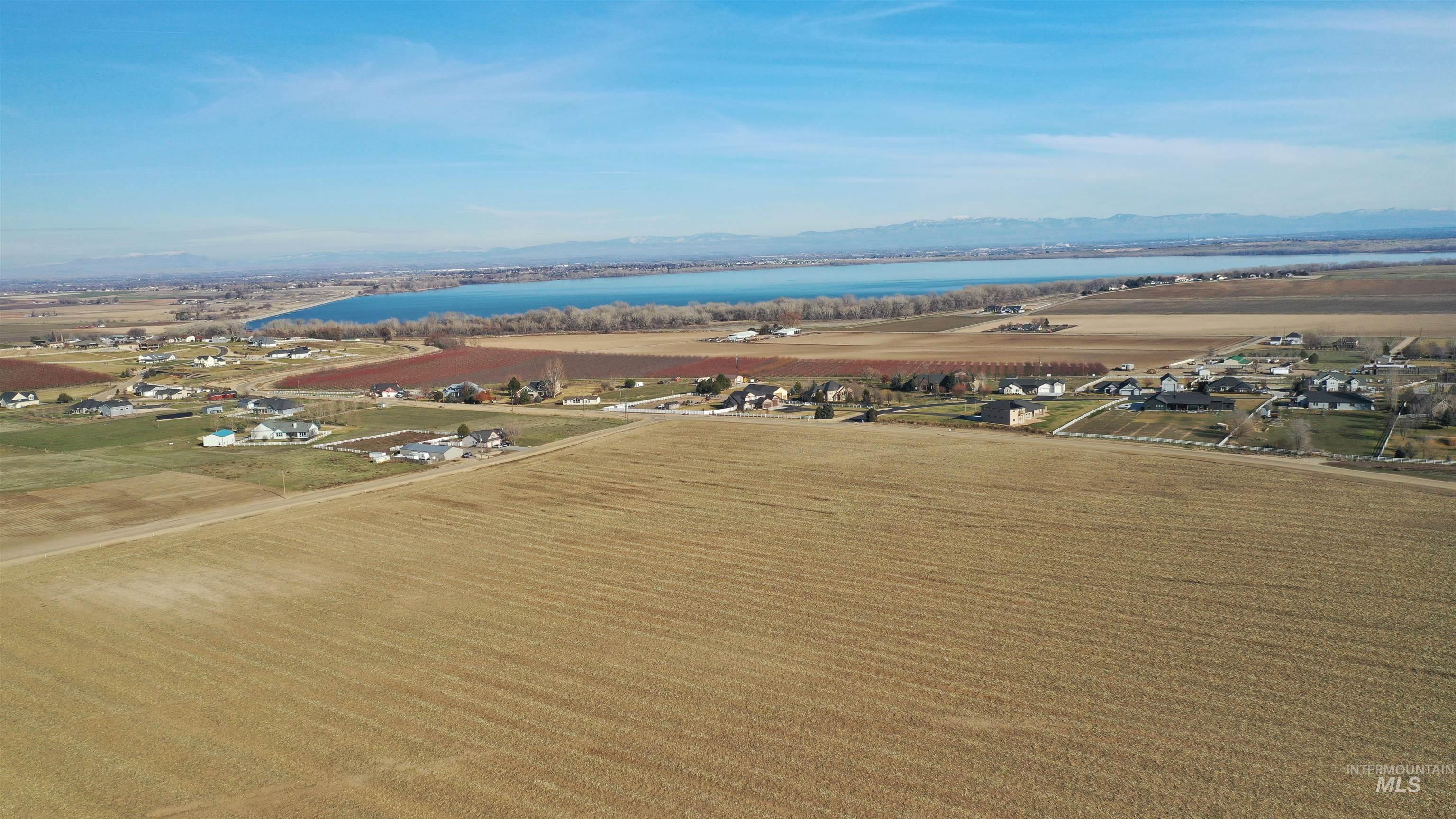 Tbd Riverside Road Caldwell, ID 83607 - Photo 23 of 35 Aerial view of property's location with a water and mountain view, rows of crops, and rural landscape