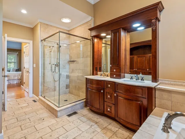 a bathroom with a shower sink and mirror